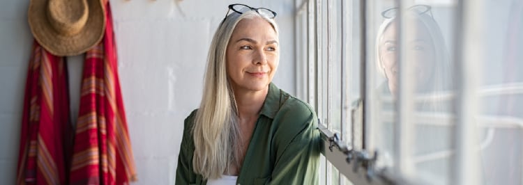 Smiling woman looking out the window