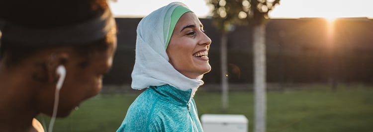 Woman in hijab exercising with a friend