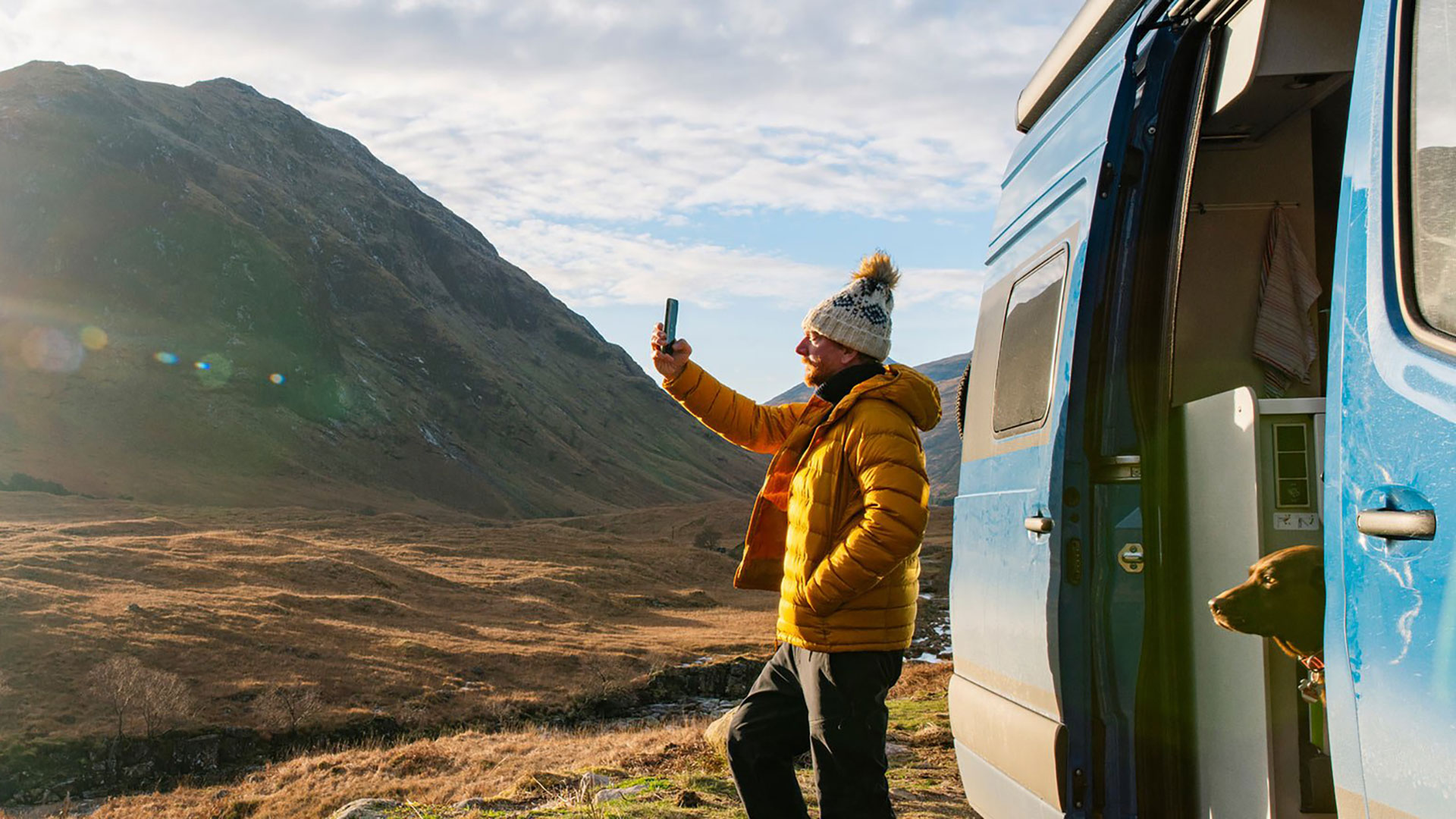 Man taking landscape picture using phone