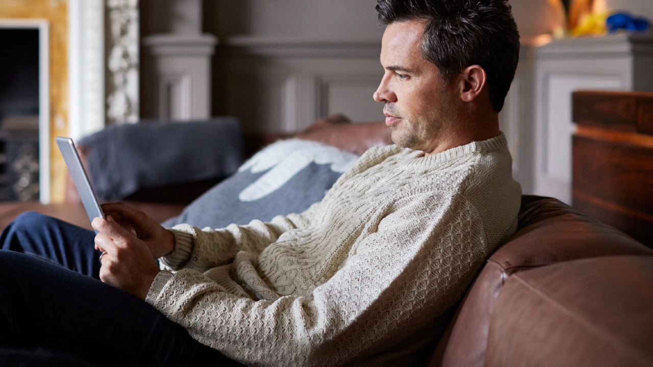 Man in his home looking at tablet device