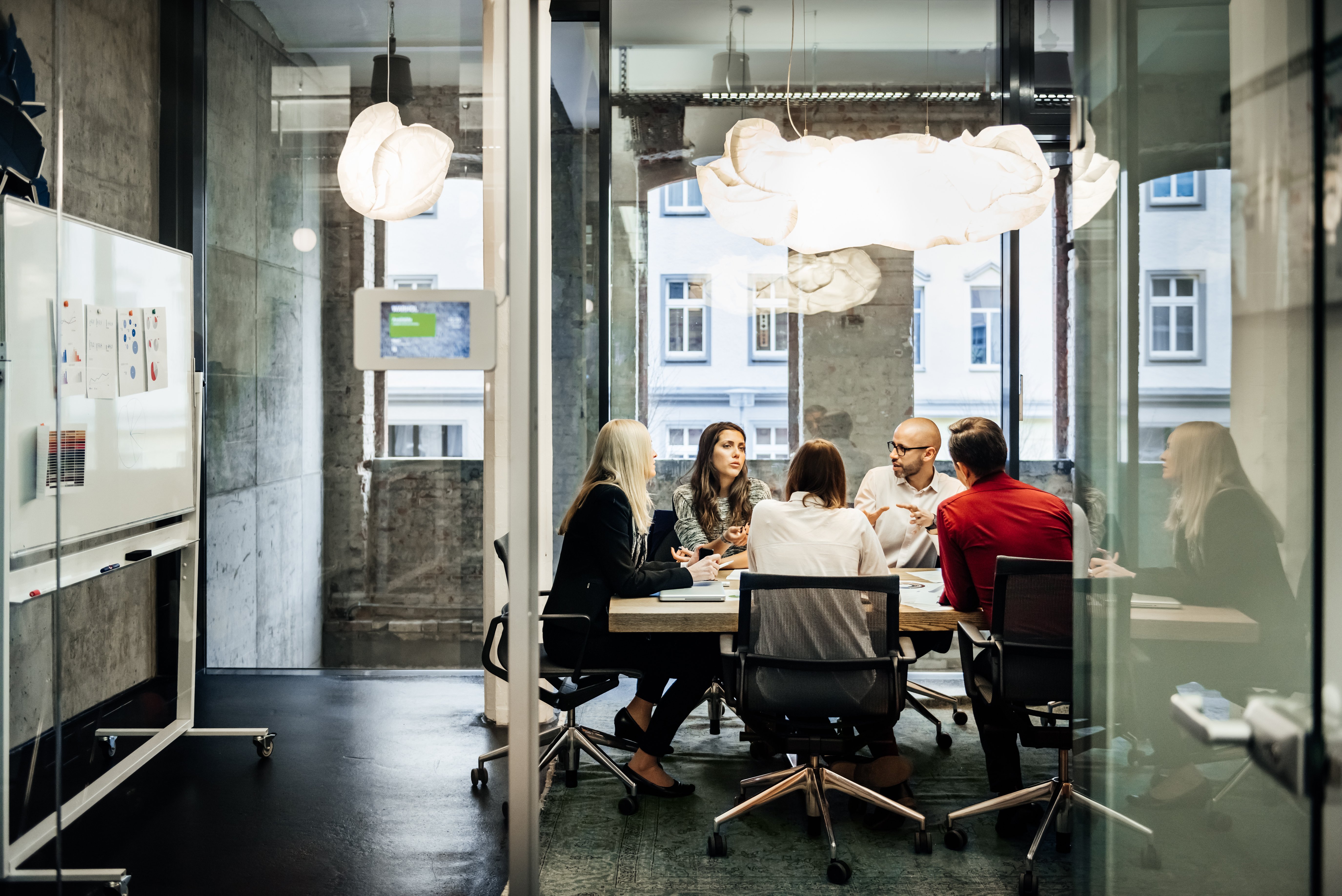 people in office sat at a table collaborating