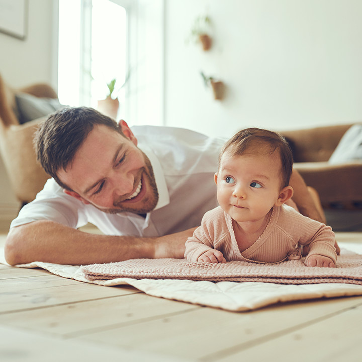 father-baby-smiling-on-floor_square&circle_720px