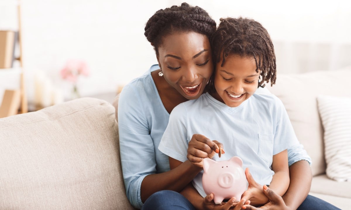 Mother and child with piggy bank