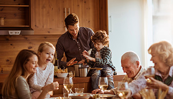 Three generations of family at dinner table