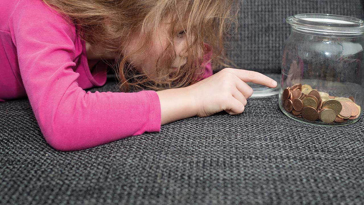 Young girl counting coins