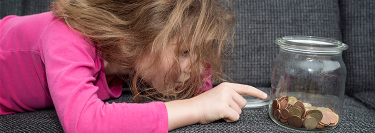 Young girl counting coins