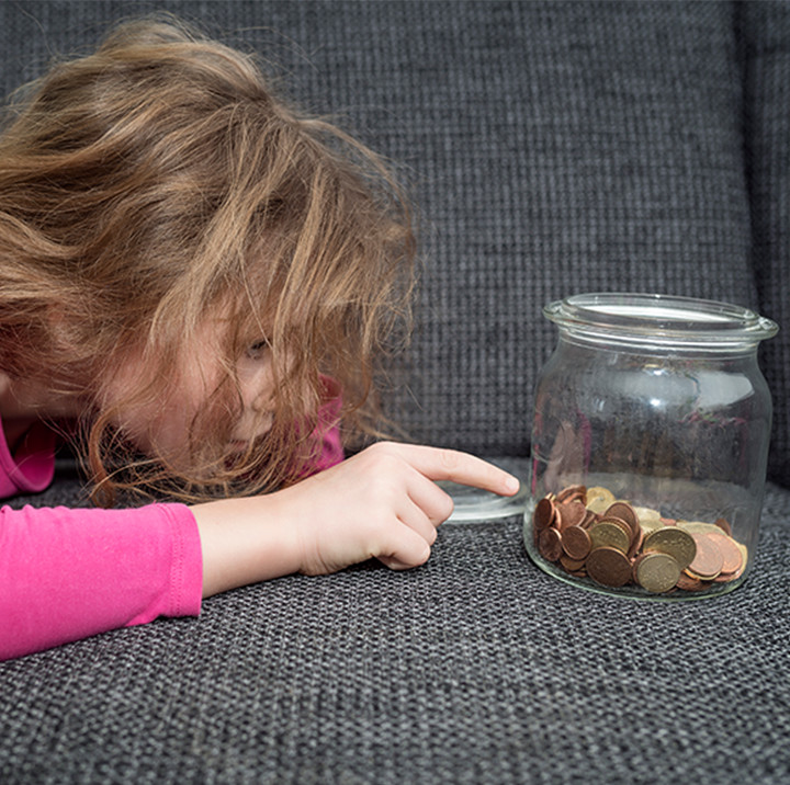Young girl counting coins