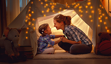 mother and daughter in tent at home_Link_block_table_355px