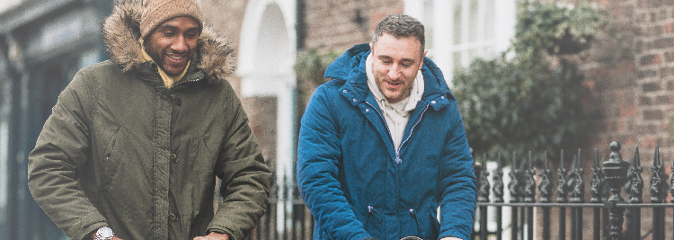 Two Dads both pushing prams