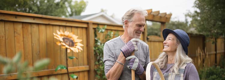 Happy middle-age couple gardening together