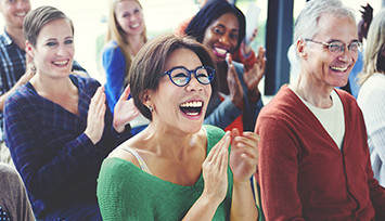 Audience smiling and clapping