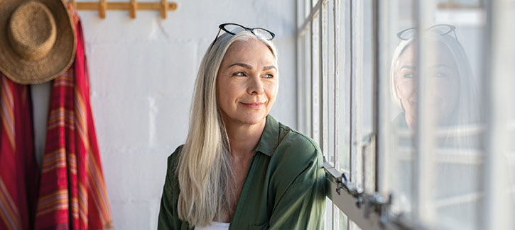 Smiling woman looking out the window