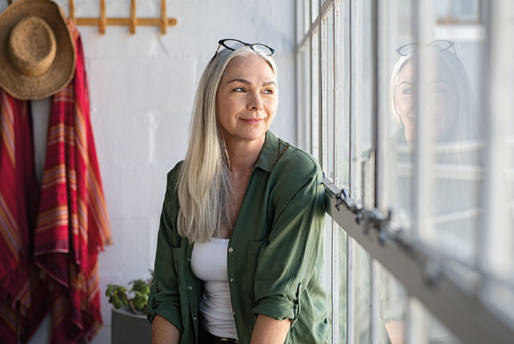 Smiling woman looking out the window