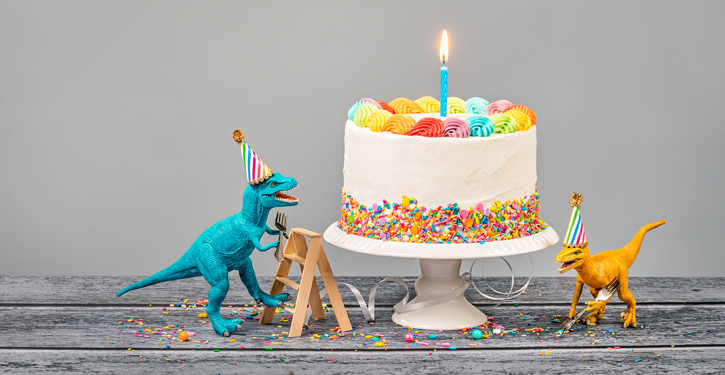 Birthday cake and toy dinosaurs
