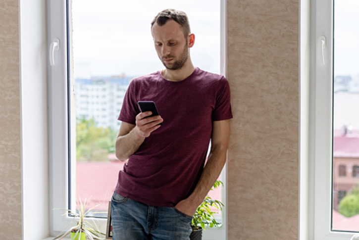 Man looking worriedly at mobile device