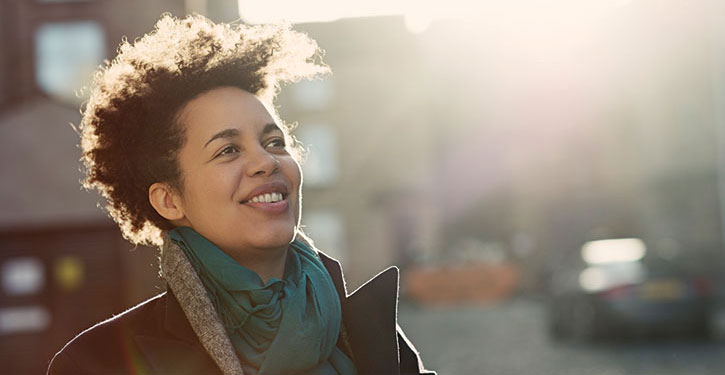 Urban smiling winter portrait of a woman in her early 40s