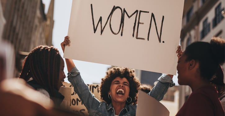 woman_holding_banner_article_hero