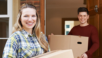 Young couple moving with boxes
