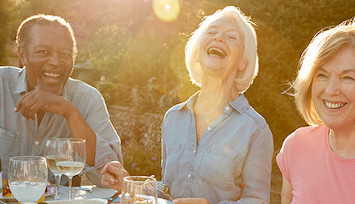 Group of friends of seniors having a dinner party outside