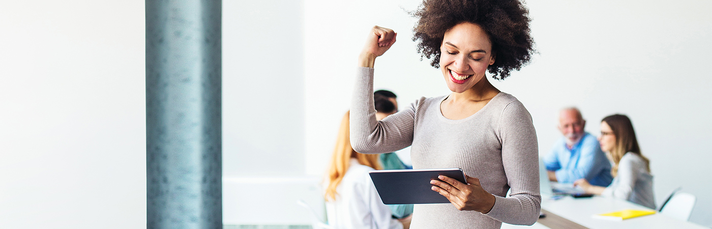 Woman smiling at tablet