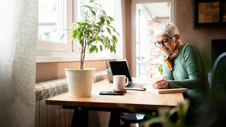 woman-on-laptop-at-desk-by-window