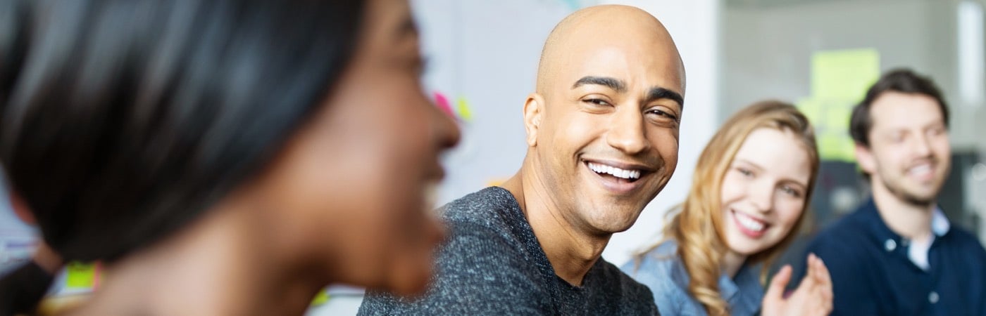 Colleagues smiling in meeting