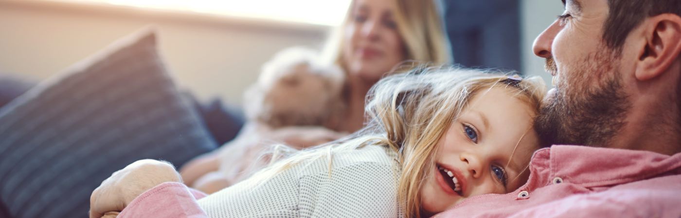 Family with young children on sofa