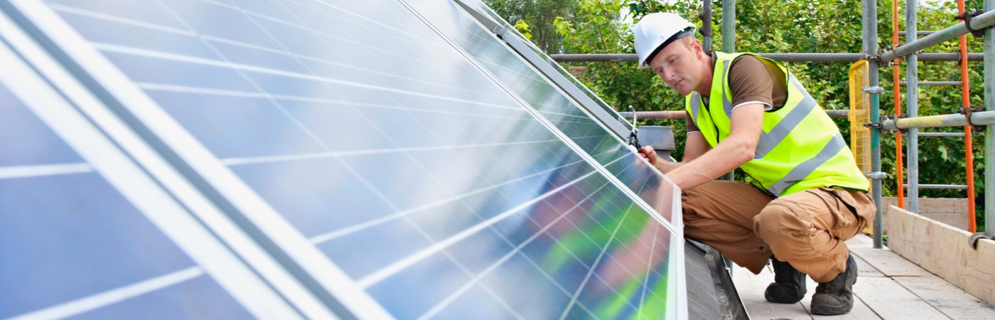 Worker installing solar panels