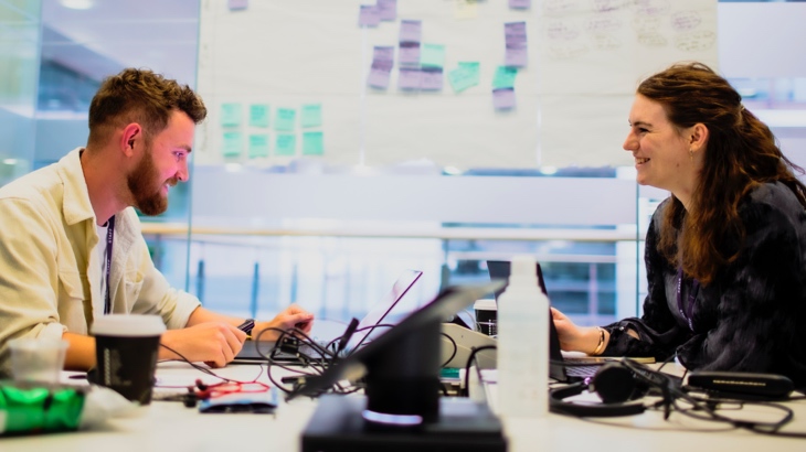 Colleagues sharing a work desk