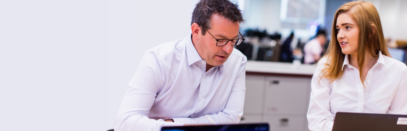 Colleagues meeting in front of laptops