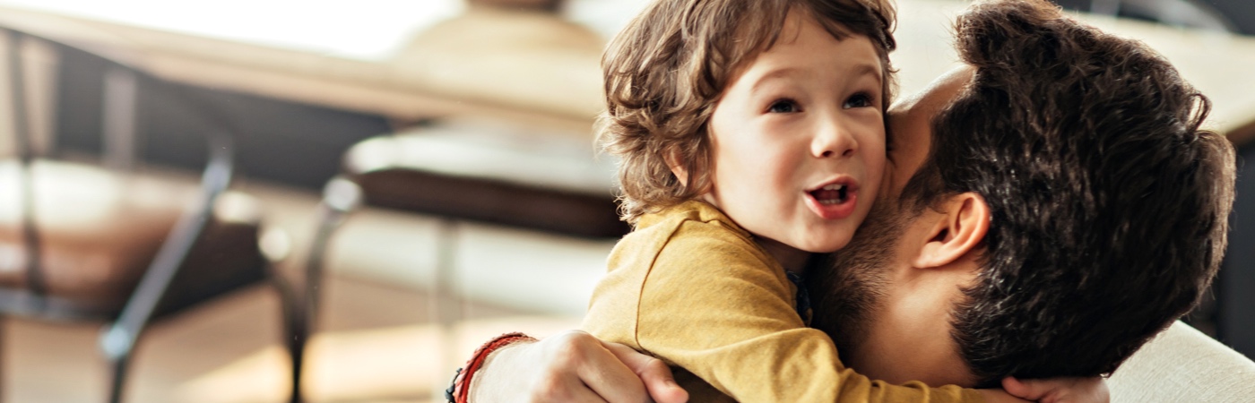 Man hugging toddler