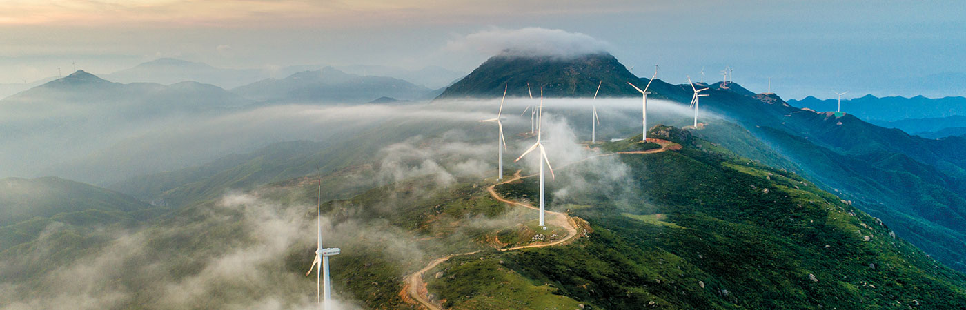 Wind turbines on a mountain range at sunset