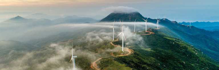 Wind turbines on a mountain range at sunset