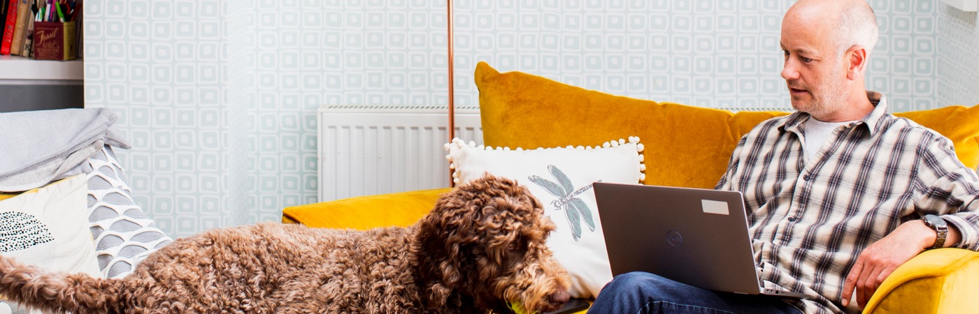 Man with dog and laptop