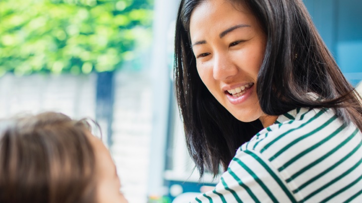 Woman smiling at child
