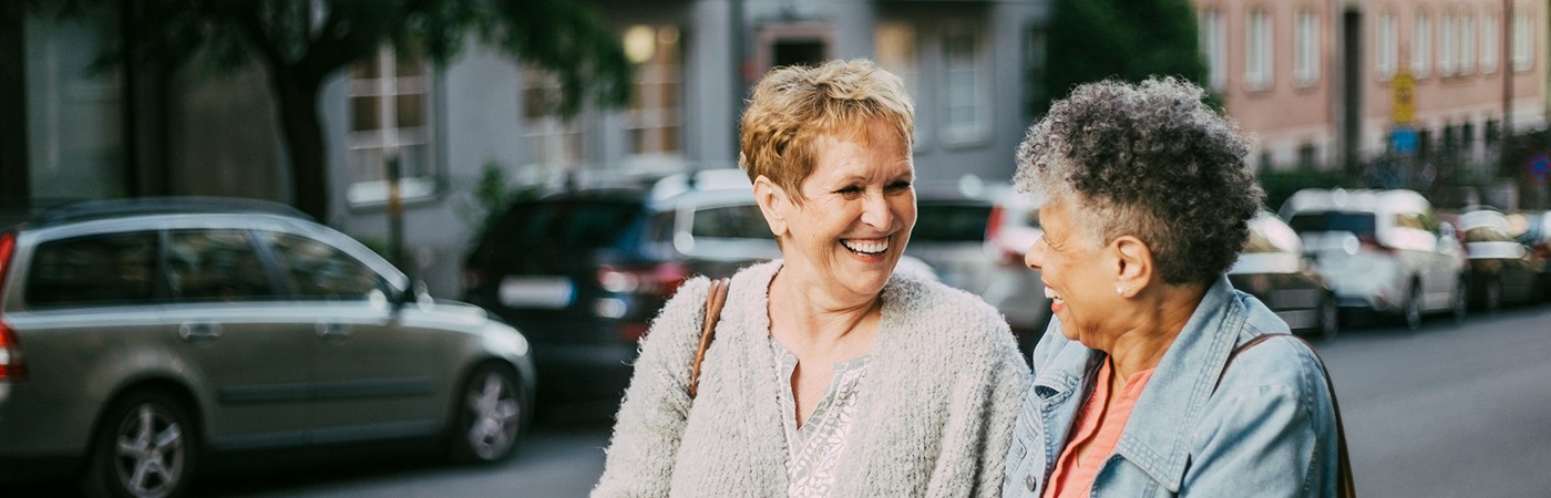 Two women chatting and laughing while walking