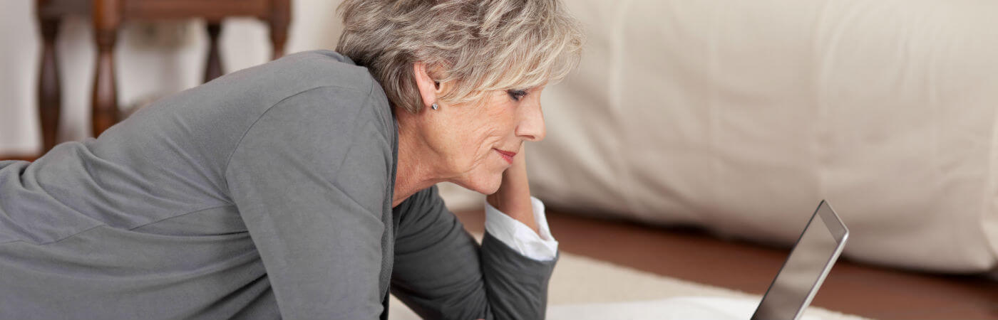 Older woman looking at a laptop screen