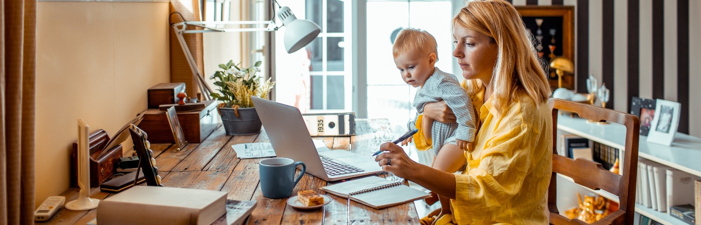 Mother and baby son at the laptop doing calculations
