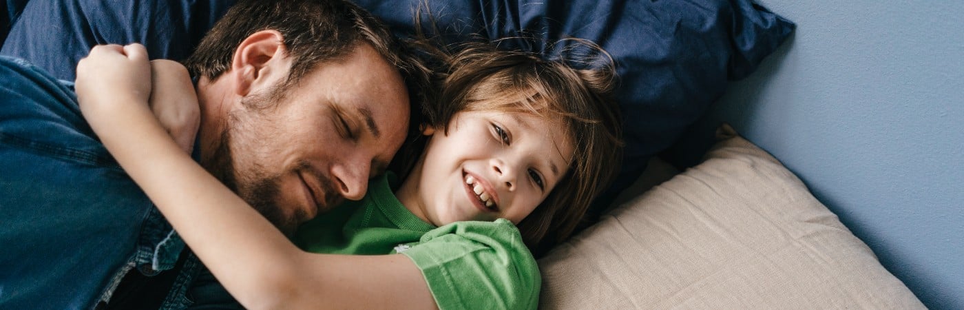 Father and son playing on the sofa