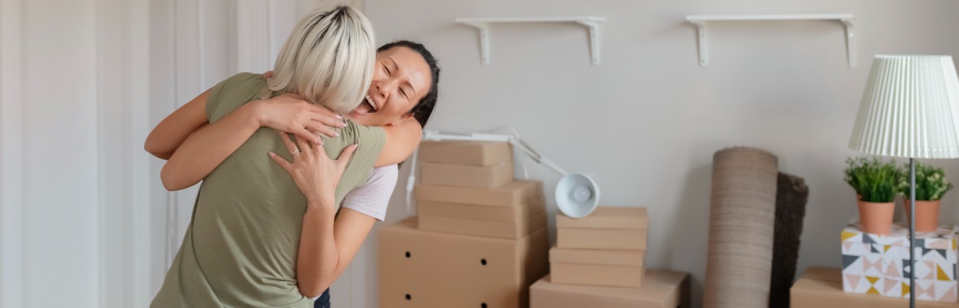 two woman celebrating in new home