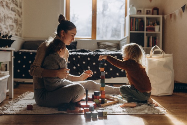 Young mum playing with children