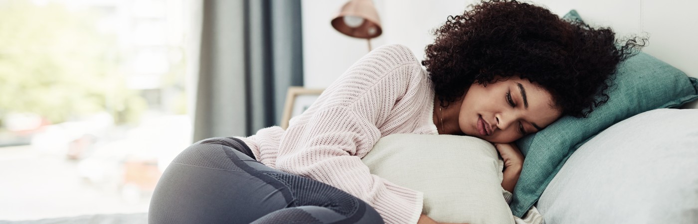 woman ill lying in bed