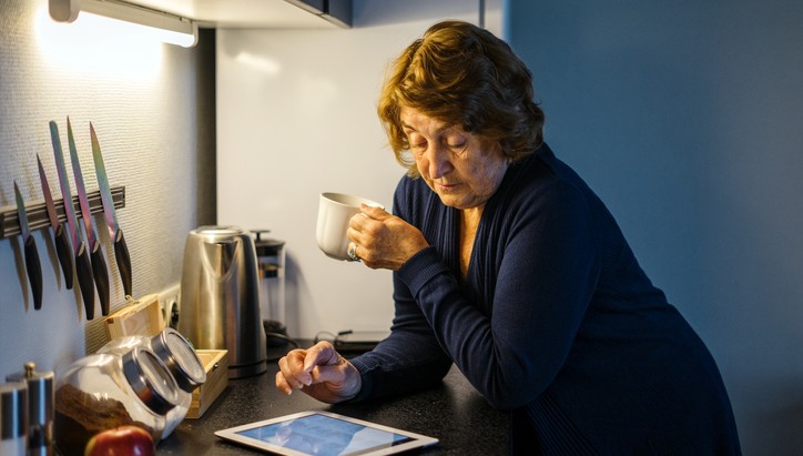 Senior lady reviewing prices online