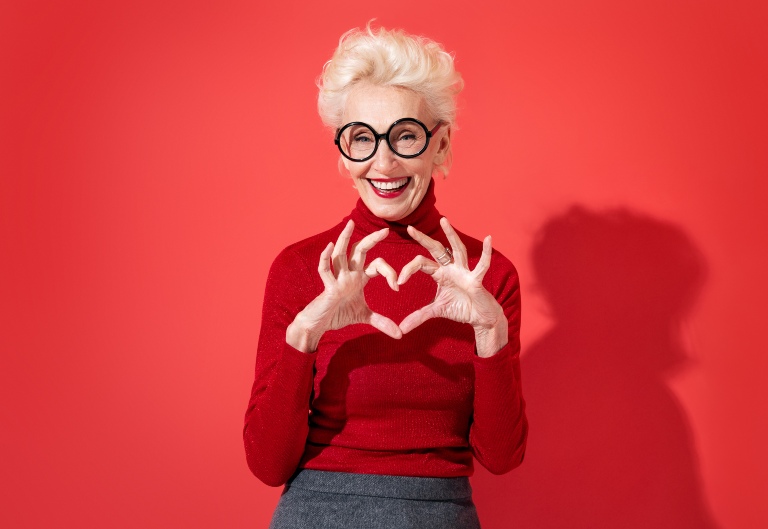 Senior woman making a heart shape