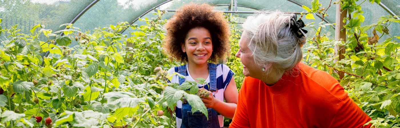 Grandmother gardening with granddaughter