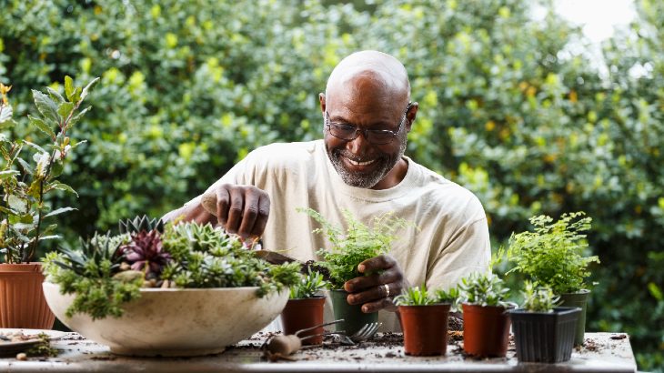 Mature man enjoying potting plants