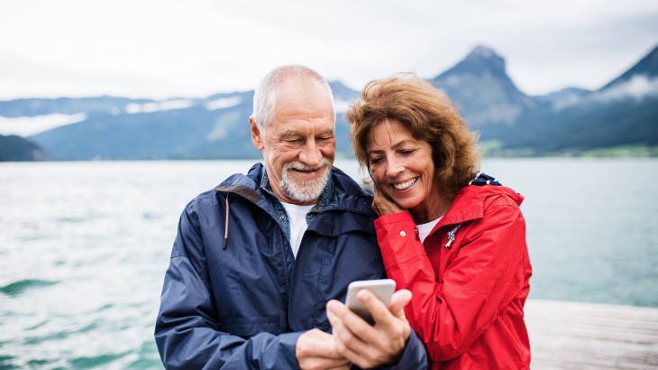 Senior man and lady talking with smart phone
