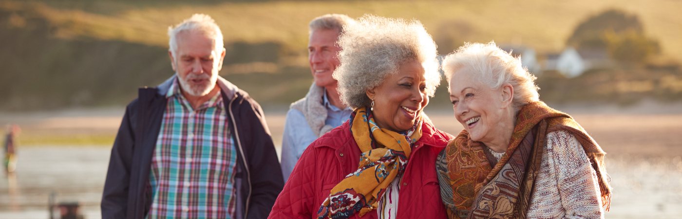 Senior couples enjoying a walk on beach