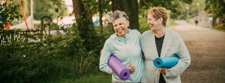 Two women holding exercise mats.jpg