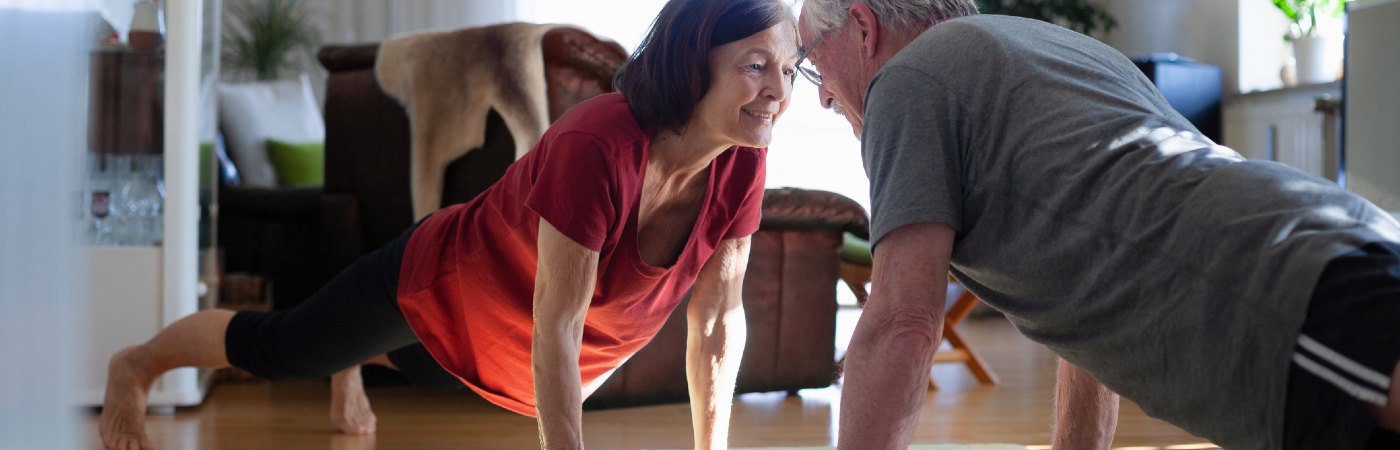 Mature couple exercising at home